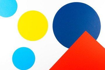 Abstract colored paper texture background. Geometric shapes and lines in pastel blue, red, yellow, navy colors on white background