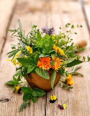 Herbal Bouquet, bouquet of various fresh herbs in a mortar on wooden table 