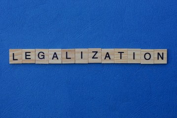 word legalization made from gray wooden letters lies on a blue background