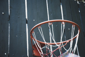 Close up of a basketball hoop with wooden backboard