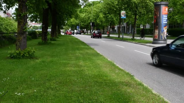 Timelapse of city traffic in a crossroad in Munich Germany. Lots of cars, ciclysts and pedestrians are in a traffic light.