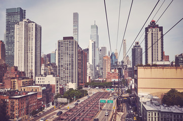 Retro toned picture of Manhattan skyline seen from the cable car, New York City, USA.