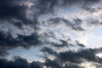 Naklejka na ściany i meble Dark clouds on a blue sky