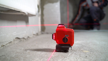 Construction laser level in a building under construction. Laser equipment at a construction site