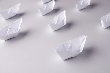 paper ships on a white background. Place for text