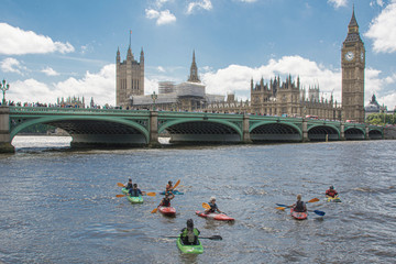 LONDON, UK - MAY 27, 2017 -  People canoeing on the River Thames in London looking at London city...
