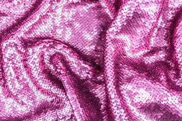 Fototapeta na wymiar Pink purple shiny fabric with sequins, abstract background.