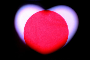 State flag of Japan in the shape of a heart. Valentine's Day. Symbol for the design and illustration of relationships and feelings. The concept of love, patriotism and independence. Dark background.