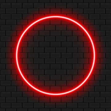 Bright Red Neon Circle Frame For Banner Or Sign Isolated On A Dark Brick Wall.