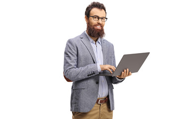 Bearded man holding a laptop computer and smiling at the camera