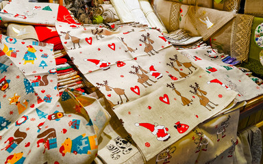 Piles of linen materials as tablecloth or clothes during the Christmas market in Riga, Latvia. Europe in winter. Street Xmas and holiday fair. Advent Decoration and Stalls with Crafts Items of Bazaar