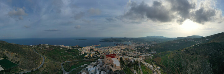Fototapeta na wymiar Aerial drone photo of iconic uphill catholic settlement of ano Syra featuring church of Saint George with beautiful colours, Syros or Siros island, Cyclades, Greece
