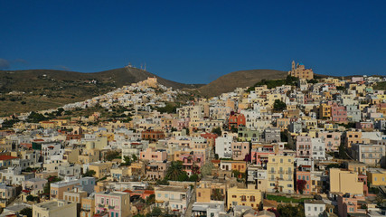 Aerial drone photo of iconic uphill catholic settlement of ano Syra featuring church of Saint...