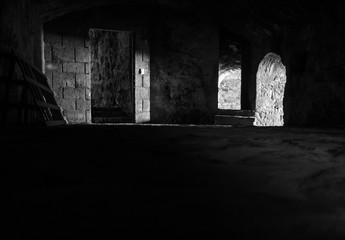 Interesting View from the inside of a dark room dungeon, with natural light entering from outside