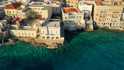 Fototapeta na wymiar Aerial drone photo of pictruesque district built by the sea of Vaporia in main town of Syros or Siros island Ermoupolis near famous church of Agios Nikolaos, Cyclades, Greece