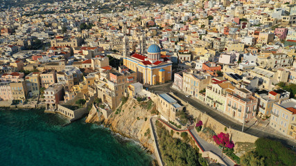Aerial drone photo of picturesque district built by the sea of Vaporia in main town of Syros or Siros island Ermoupolis and famous church of Agios Nikolaos, Cyclades, Greece