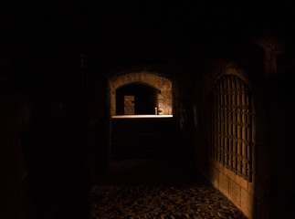 Interesting View from the inside of a dark room dungeon, with natural light entering from outside