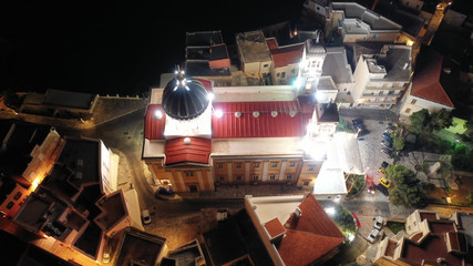 Aerial drone night shot of iconic illuminated church of Agios Nikolaos in famous district of Vaporia in main town of Syros island - Ermoupolis, Cyclades, Greece