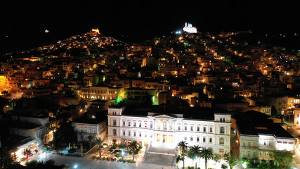 Aerial drone night shot of neoclassic landmark building of Ermoupolis town city hall in Miaouli square, Syros or Siros island, Cyclades, Greece