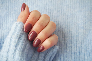 Violet manicure and blue sweater.