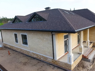 Bituminous tile for a roof. House with a roof from a bituminous