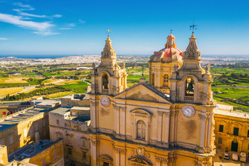 Mdina city - old capital of Malta. Aerial nature landscape, sunny day, blue sly, winter, a lot of green grass, field. Malta