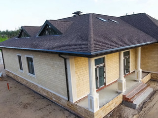 Bituminous tile for a roof. House with a roof from a bituminous