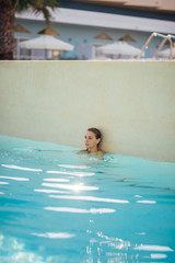 Young attractive woman in the pool