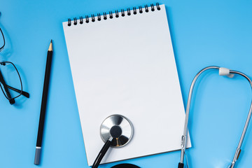 Stethoscope on a blue table, concept of medicine
