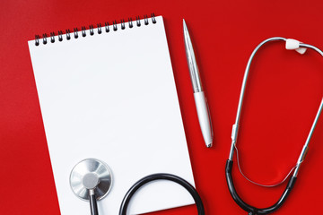 Stethoscope on a red table, concept medicine