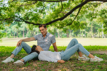 Naklejka na ściany i meble two caucasian lover couple having romance moment in park together