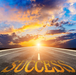 Write "success" on the empty asphalt road straight ahead. Creative drawings of successful concepts.