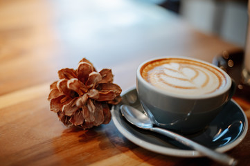 Hot latte coffee decorated with pine cones