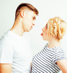 young pretty teenage couple, hipster guy with his girlfriend happy smiling and hugging isolated on white background, lifestyle people concept