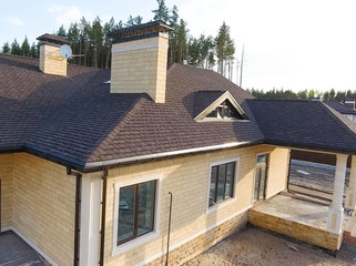 Bituminous tile for a roof. House with a roof from a bituminous tile. a roof from a bituminous tile. Moder