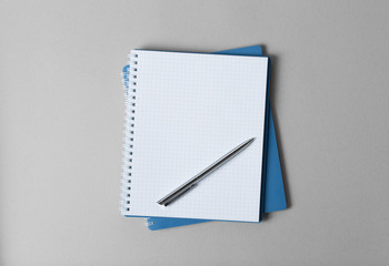 notebook with pencil on a gray background