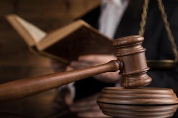 Justice and law concept, Male judge in a courtroom striking the gavel
