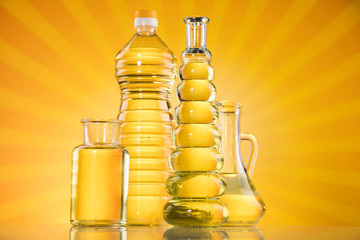Rapeseed oil, sunflower oil, olive oil on sunburst orange background