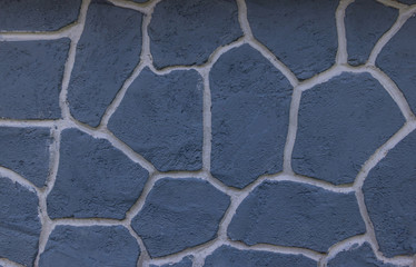 Light blue stone wall. With white lines divided into compartments. Texture background has an artistic pattern.