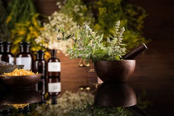 Natural medicine in black mirror background