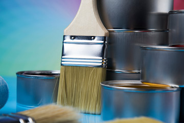Tin cans with paint and brushes