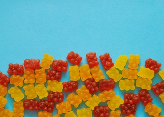 Gummy bear vitamin on colorful background.