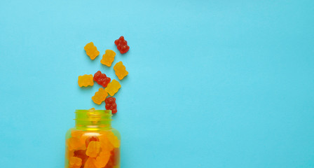 Gummy bear vitamin on colorful background.