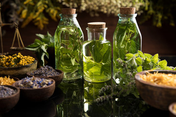Oil and Natural medicine, wooden table background