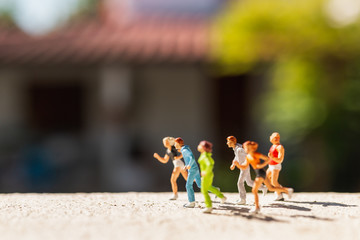 Miniature people : Group of people are running  on concrete road ,  Healthy and lifestyle concept