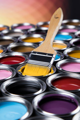 Tin cans with paint and brushes