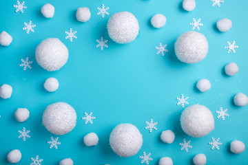 Fototapeta na wymiar Christmas, winter frame of white balls and snow. Snowy Christmas pattern on a light blue background Winter holiday