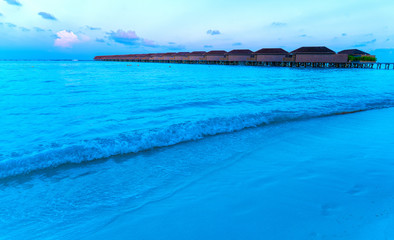Wooden bridges leading to the huts on the shores of the tropical