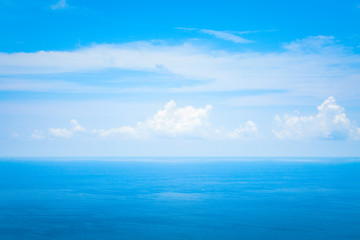 Background Texture of Ocean Skyline with Tropical Beach against Blue Sky and White Clouds in Summer Sunny Day