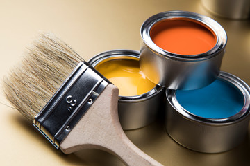 Metal tin cans with color paint and paintbrush